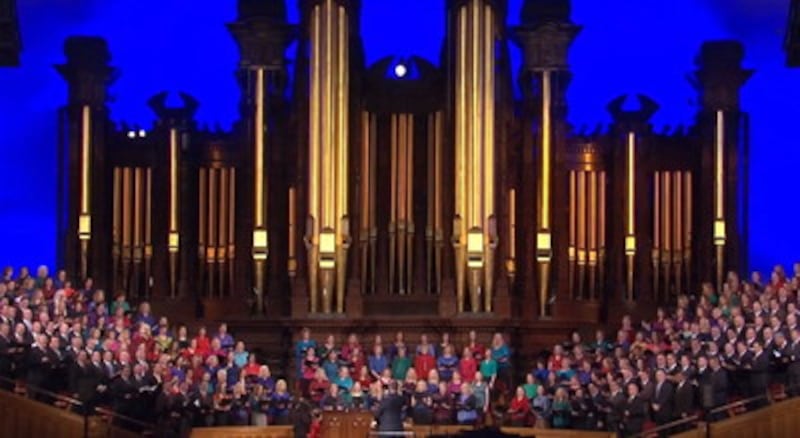 A choir, composed of CES staff and spouses, performs during a devotional in the Tabernacle.