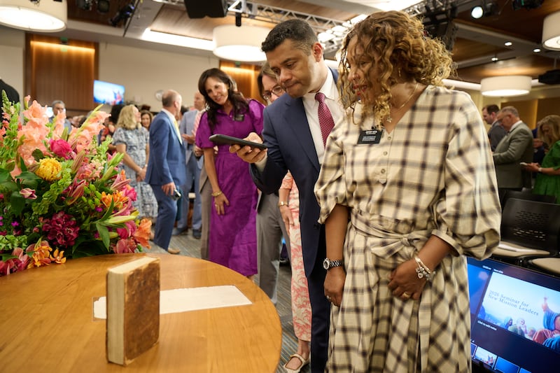 New mission leaders line up to see and photograph an 1830 first edition copy of the Book of Mormon and a page of the original manuscript at the 2026 Seminar for New Mission Leaders at the Provo Missionary Training Center in Provo, Utah, on Friday, June 19, 2026.