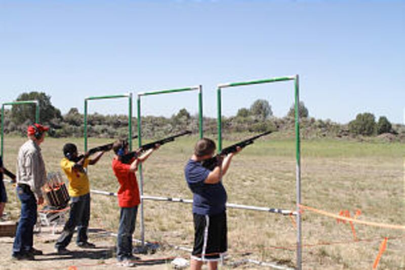 Under the careful eye of the range master, a trio of Scouts enjoy trap shooting at the 2013 Rise Up