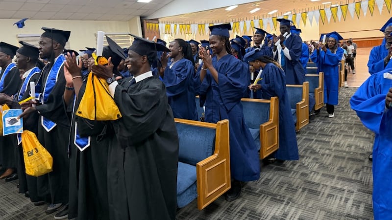 Participants and graduates stand up to cheer concluding the BYU Pathway Completion Ceremony in Nairobi, Kenya. April 25, 2026.