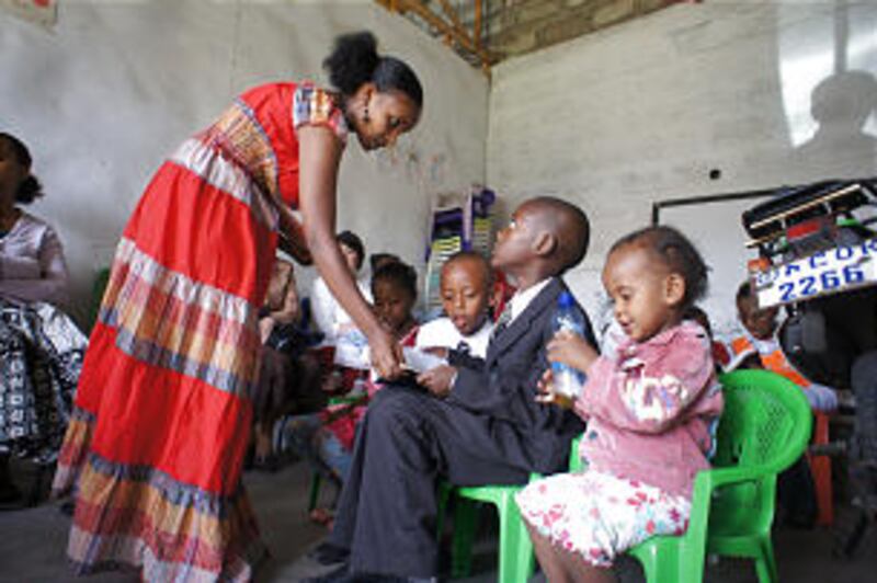 Ethiopian primary children are taught in an older building as construction for the new Debre Zeit bu