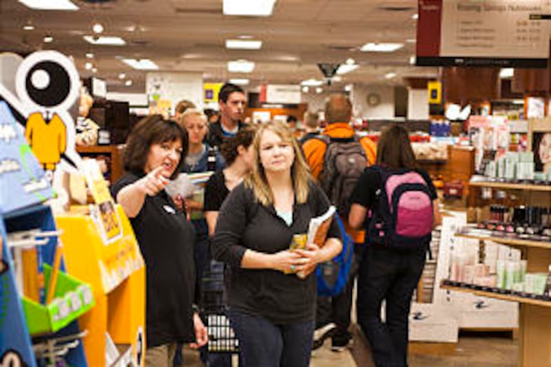 A bookstore employee directs a student during busy hours at the beginning of the fall 2012 semester.