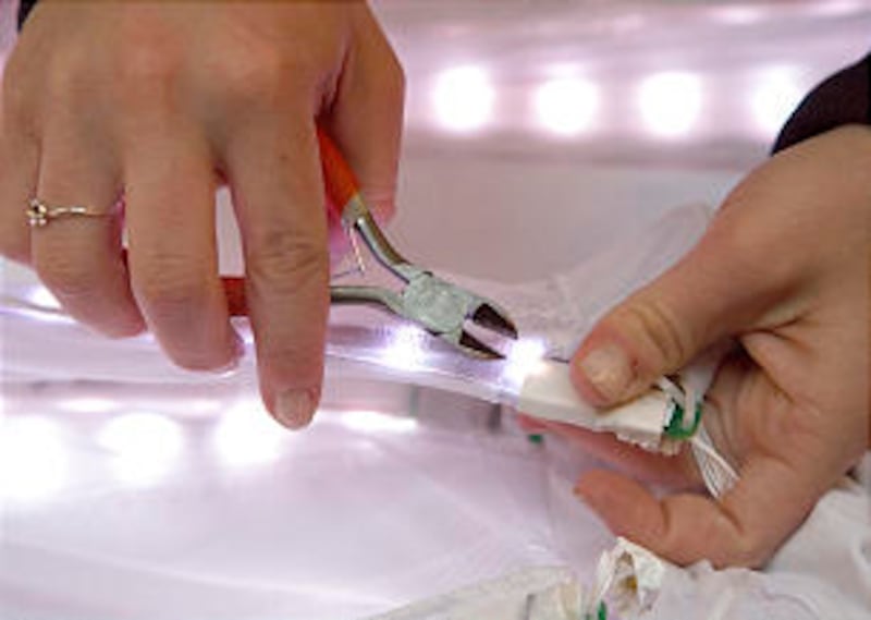 LED lights located every inch or so attach to a slip under the specially designed light dresses. Eac