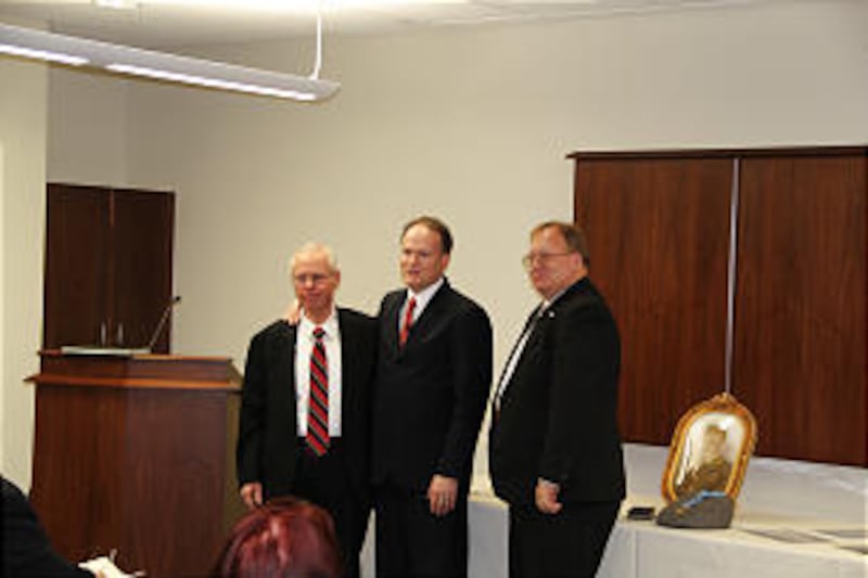 Elder Marcus Nash, center, with Jay McKenzie, left, and military historian Sherman Fleek.