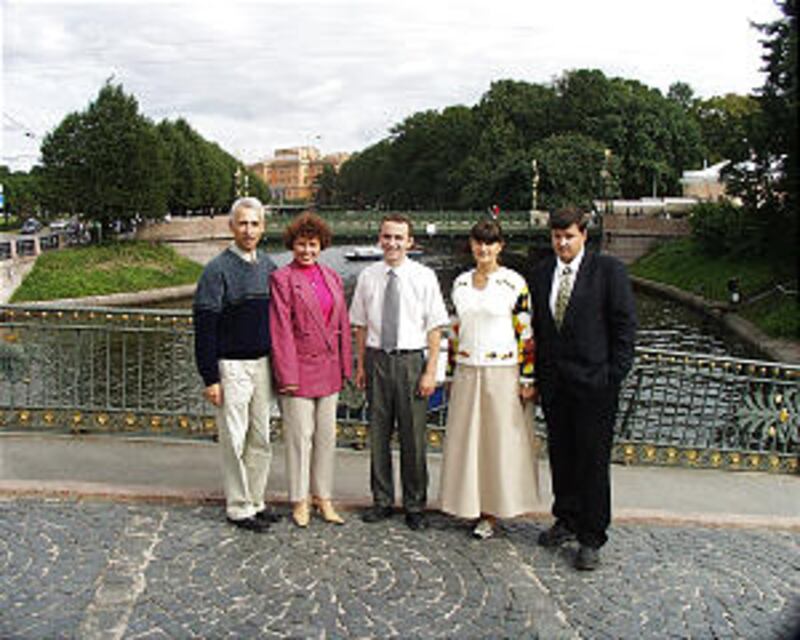 On a bridge over the Moika River with Mikhailevsky Castle in background are Valentina & Mihail Zaret
