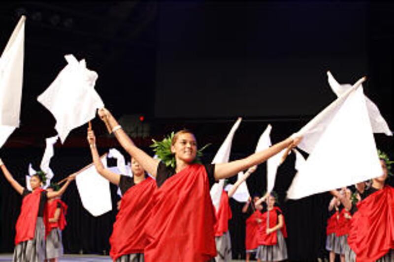 Youth from the Laie Hawaii North Stake wave white flags, representing the white flags that once mark