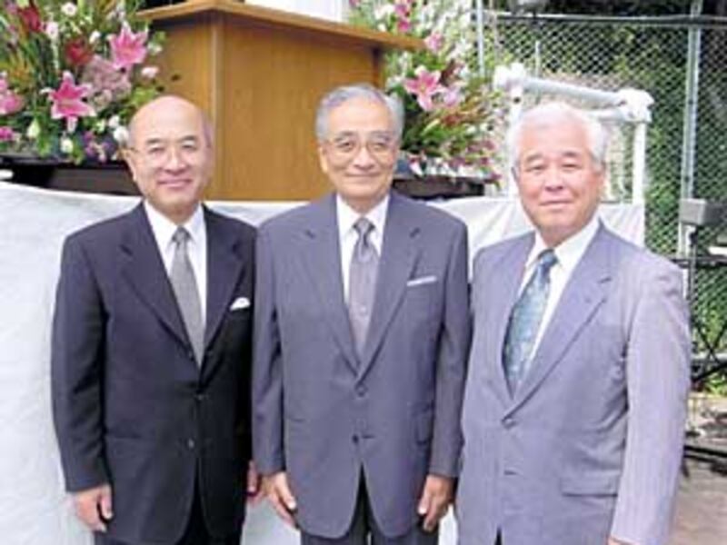 The first presidency of the first stake in Japan took part in the centennial. Kenji Tanaka, center,