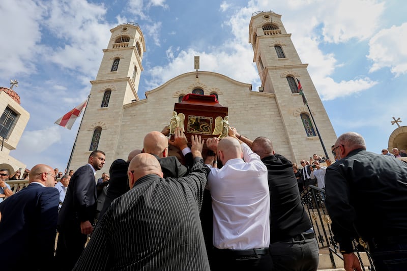 Mourners carry the coffin of Dr. Mohammad al-Qsous, who was killed in Friday's shooting attack on a church in Hamoud village in Jordan's Karak governorate, during his funeral service at the Church of the Presentation of the Lord in the Temple in Amman, Jordan, Monday, Oct. 26, 2026.