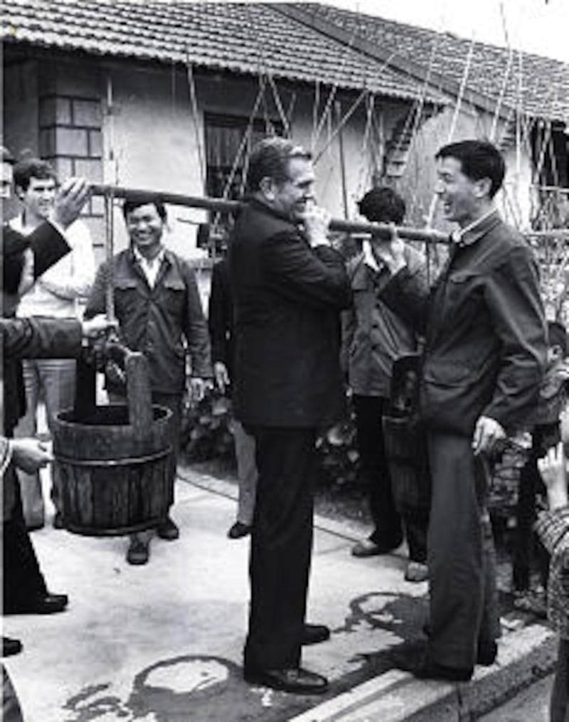In 1985, during a visit to Asia, Elder Boyd K. Packer evokes laughter from Chinese workmen in Canton