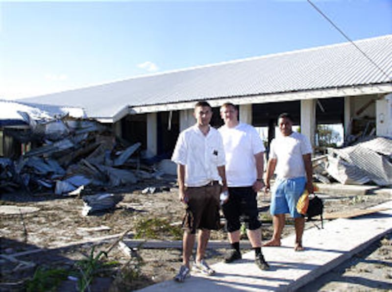 Missionaries of the Samoa Apia Mission, including, left, Elder Elliott Miller, survey meetinghouse d