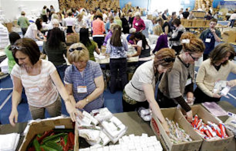 Women assemble hygiene kits during the BYU Women's Conference evening of service in Provo Thursday,