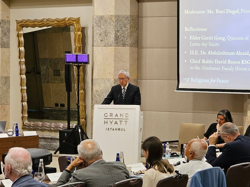 Elder Gerrit W. Gong stands at a lecturn to give a presentation about artificial intelligence during a session of the World Council of Religions for Peace in Istanbul, Turkey, Tuesday, July 29, 2025.