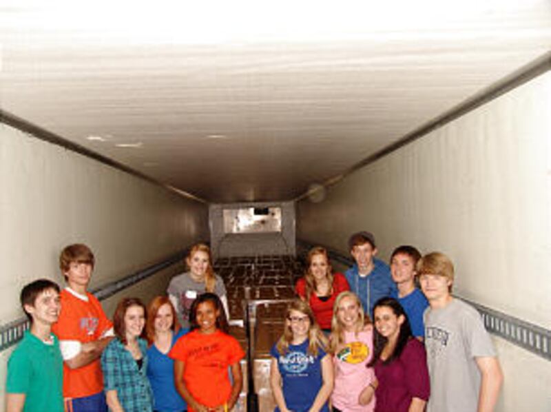 Local LDS youth stand inside a trailer at the Tucker Georgia Bishops' Storehouse that was filled wit
