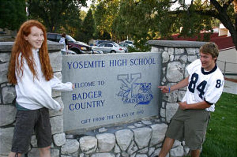 Oakhurst Ward youth Hannah Stutzman and Blaine Burrow show off their school sign.