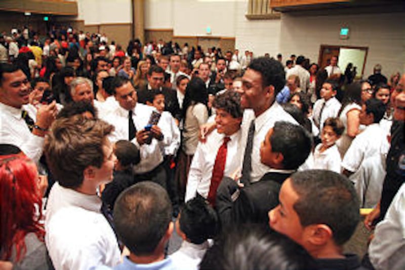 Jabari Parker visits with other youth after he spoke at a devotional for the Oakland California East