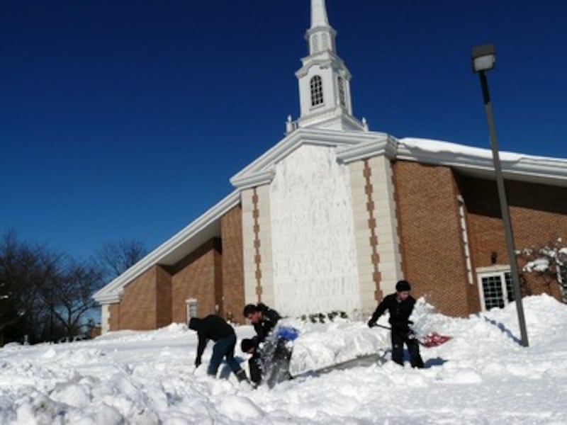 Members of the Centreville Second Ward teachers quorum have fun shoveling on a no-school Monday.