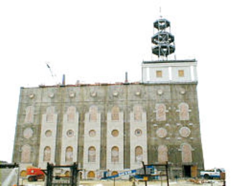 Steel framing for Nauvoo temple tower and some rock facing on concrete wall are visible in this rece