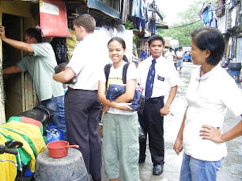 Missionaries and members of the Paranaque 4th Ward, Paranaque Philippines Stake, visit members' home