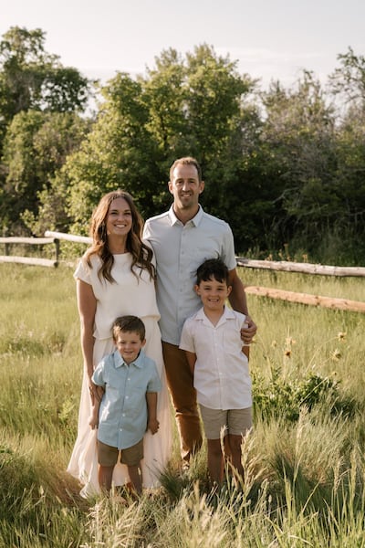 A beard-less Ladd Howell and his wife, Brittney Howell, stand for a family portrait with their two sons in Smithfield, Utah, in 2025.