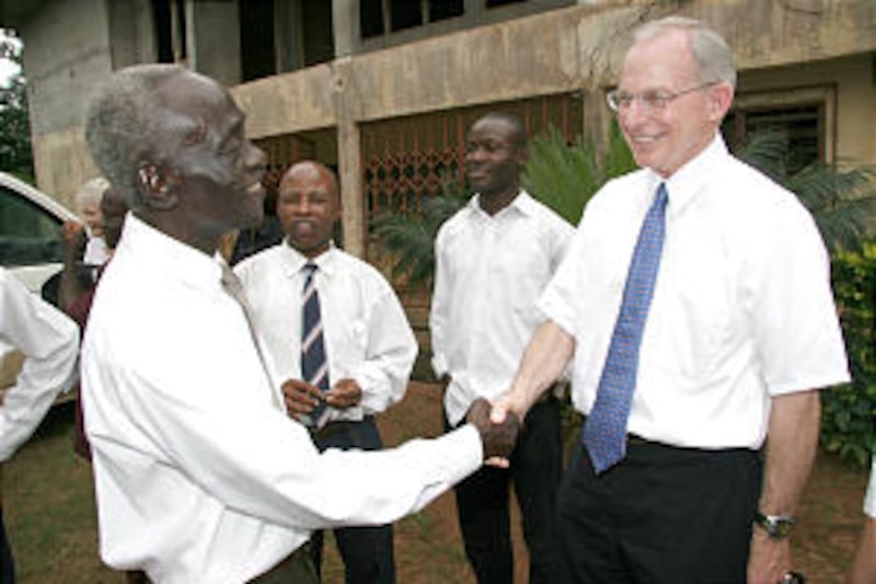 The brother of Anthony Obinna, Raymond, greets Ralph Mabey, the son of Elder Rendell Mabey, one of t