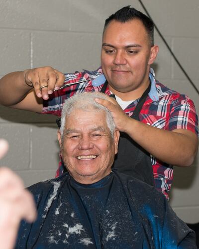 A man experiencing homelessness gets a free haircut at a haircutting station at a Project Connect event in the metro Phoenix area.