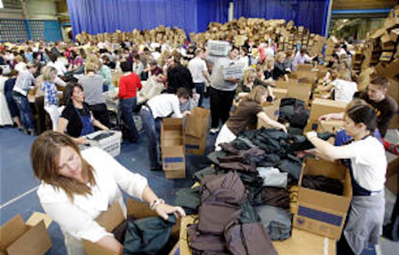 Volunteers box assembled school kits during the BYU Women's Conference evening of service in Provo