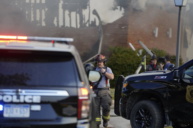 Emergency responders work the scene outside a meetinghouse of The Church of Jesus Christ of Latter-day Saints following a shooting and fire in Grand Blanc, Michigan, Sunday, Sept. 28, 2025.