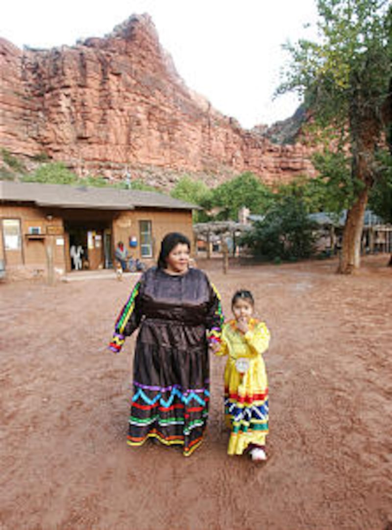 LDS church members xxxxx walks with her grandaughter Decovan Uqualla on the the Havasupai Indian re