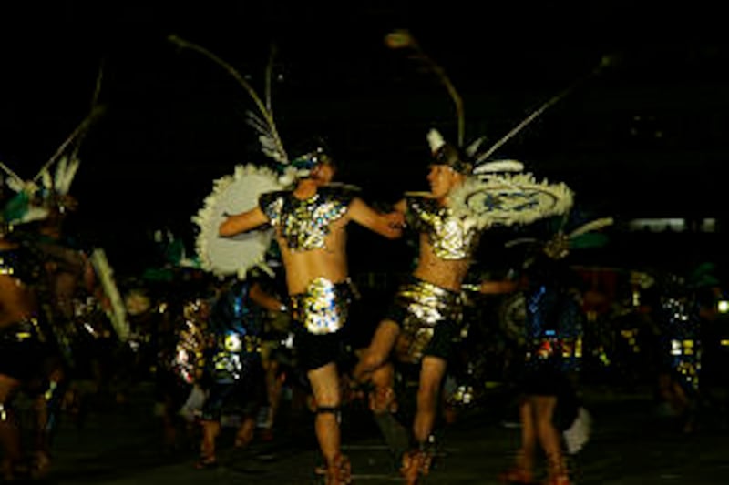 Performers in Aztec regalia re-enact battle scenes from Mexico's pre-Columbian history. Video clips