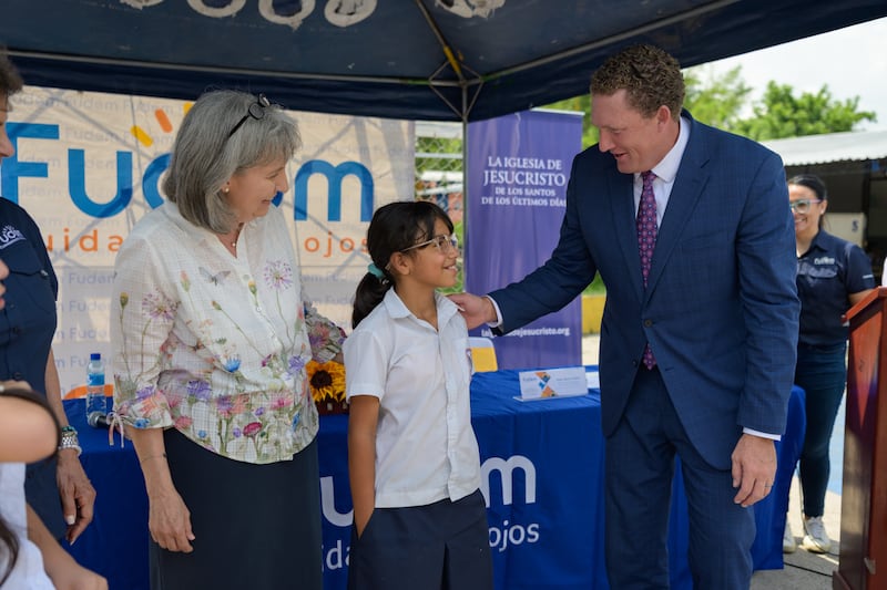 Sister J. Anette Dennis and Elder Ryan K. Olsen announce the donation of eyeglasses and vision screenings in San Salvador, El Salvador, on Friday, June 5.