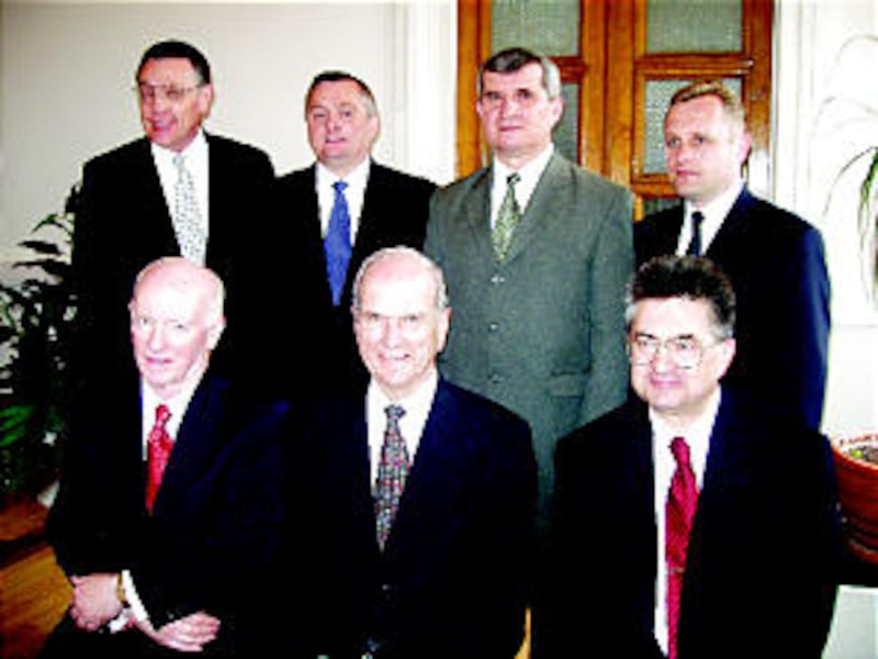 Elder Russell M. Nelson, front center, accompanied by Elder Douglas L. Callister, left, and Elder Al