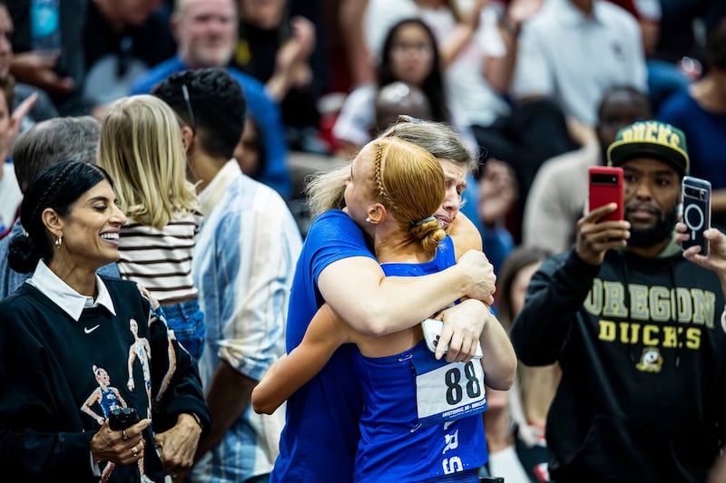 BYU's Jane Hedengren receives a hug after winning a national title in the 5,000-meter race.