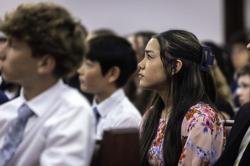 A young woman and other youth in Toronto, Canada, listen to President D. Todd Christofferson, second counselor in the First Presidency, at a devotional on Saturday, June 13, 2026.
