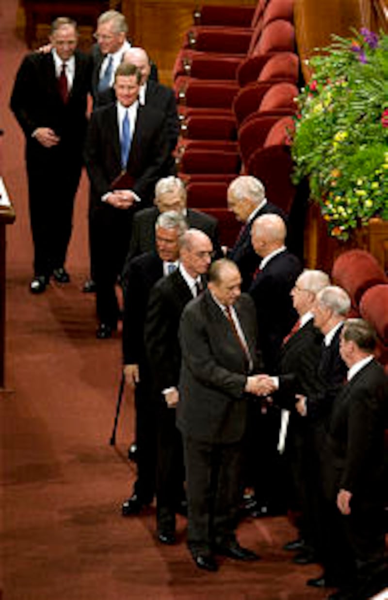 The First Presidency pauses to greet and express appreciation to members of the Quorum of the Twelve
