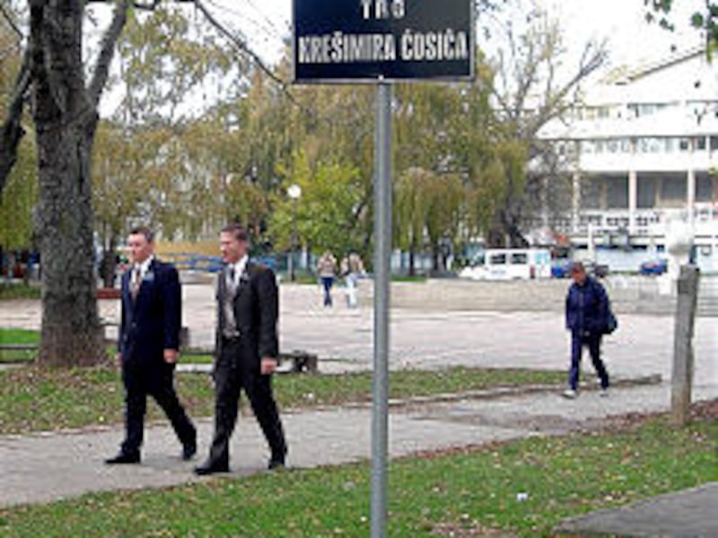 Elder John T. Moore and Elder Skyler R. Brunner stroll past sign denoting Kresimir Cosic Square.