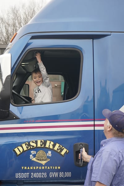 A young boy pulls a semitruck air horn as food donations from The Church of Jesus Christ of Latter-day Saints are unloaded from a truck at Feeding Westchester in Elmsford, New York, on Thursday, March 19, 2026.