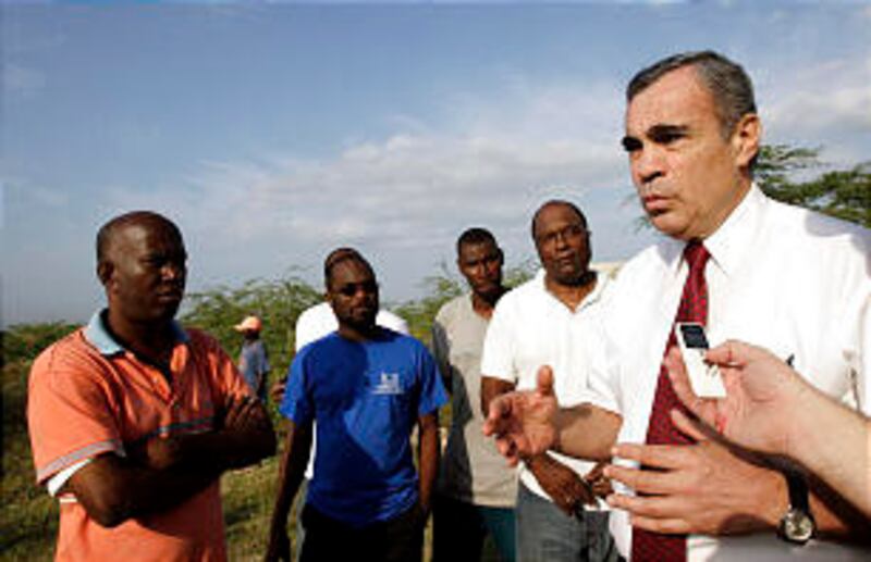 Caribbean Area President Francisco Vinas, right, talks with Port-au-Prince Stake President Francillo